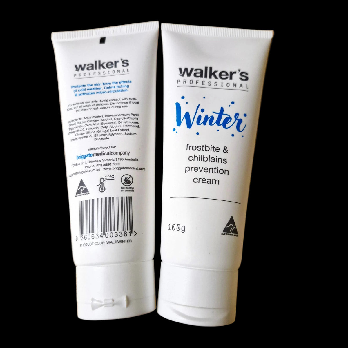 Two white squeeze tubes of Walker's Professional Winter Frostbite & Chilblains Prevention Cream placed side-by-side on a light brown wooden surface. The left tube shows the back with text and a barcode, and the right tube shows the front with the product name 'Winter' in blue script.